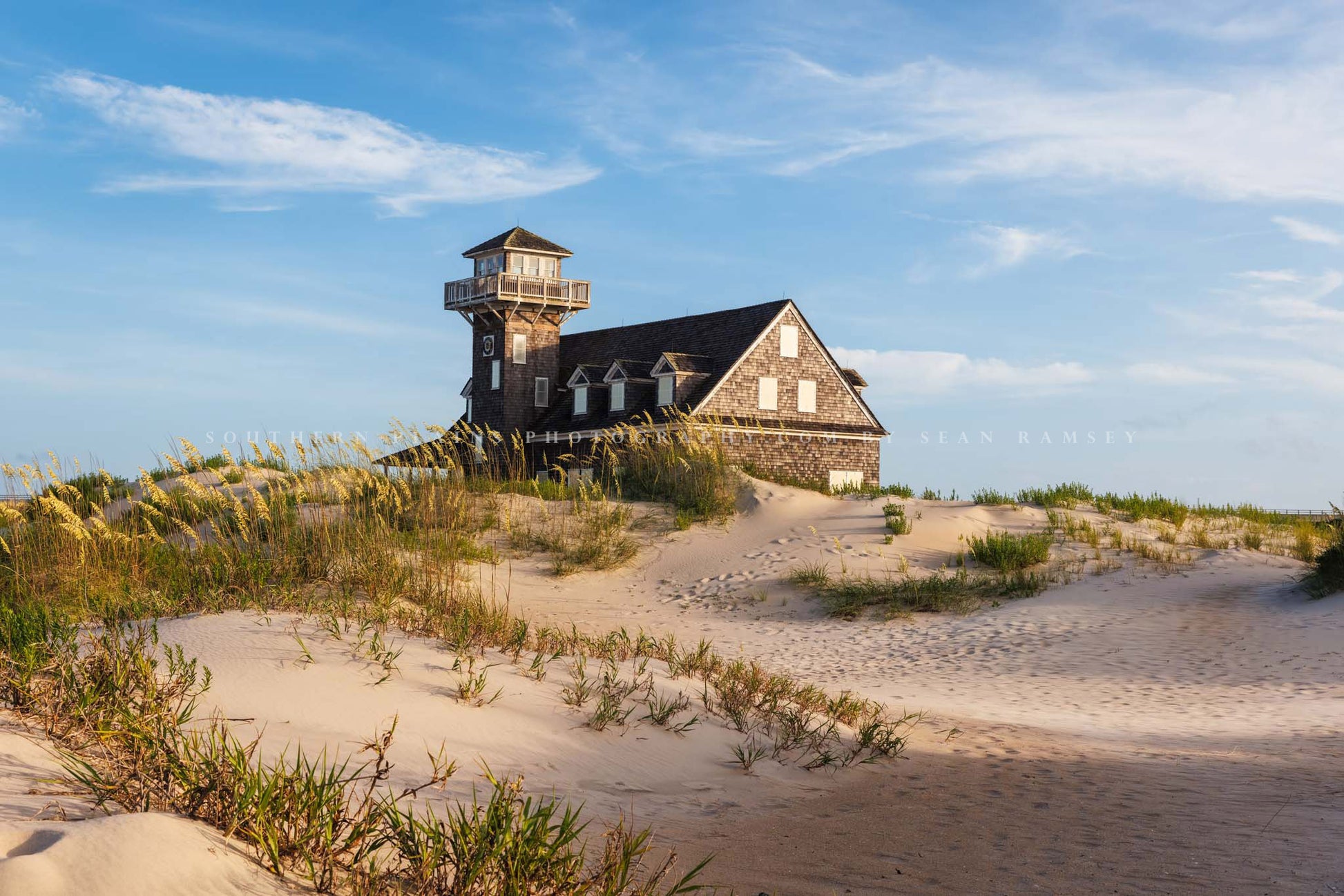 Coastal OBX photography print of the historic Oregon Inlet Lifesaving Station nestled among sand dunes in the Outer Banks near Rodanthe, North Carolina by Sean Ramsey of Southern Plains Photography.