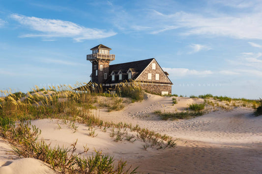 Coastal OBX photography print of the historic Oregon Inlet Lifesaving Station nestled among sand dunes in the Outer Banks near Rodanthe, North Carolina by Sean Ramsey of Southern Plains Photography.