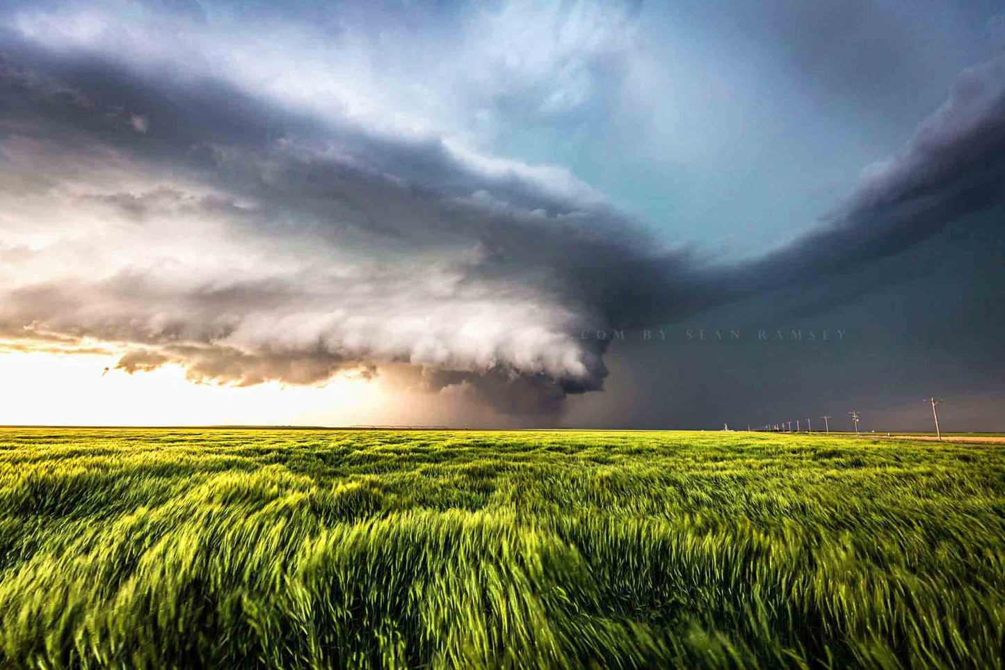 Storm photography print of a powerful supercell thunderstorm advancing over waving wheat on a stormy spring day in Kansas by Sean Ramsey of Southern Plains Photography.
