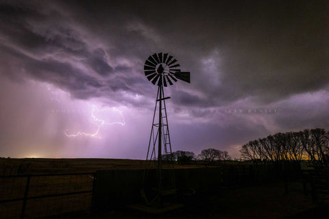 Storm photography print of lightning illuminating the sky beside an old windmill on a stormy spring night in Oklahoma by Sean Ramsey of Southern Plains Photography.