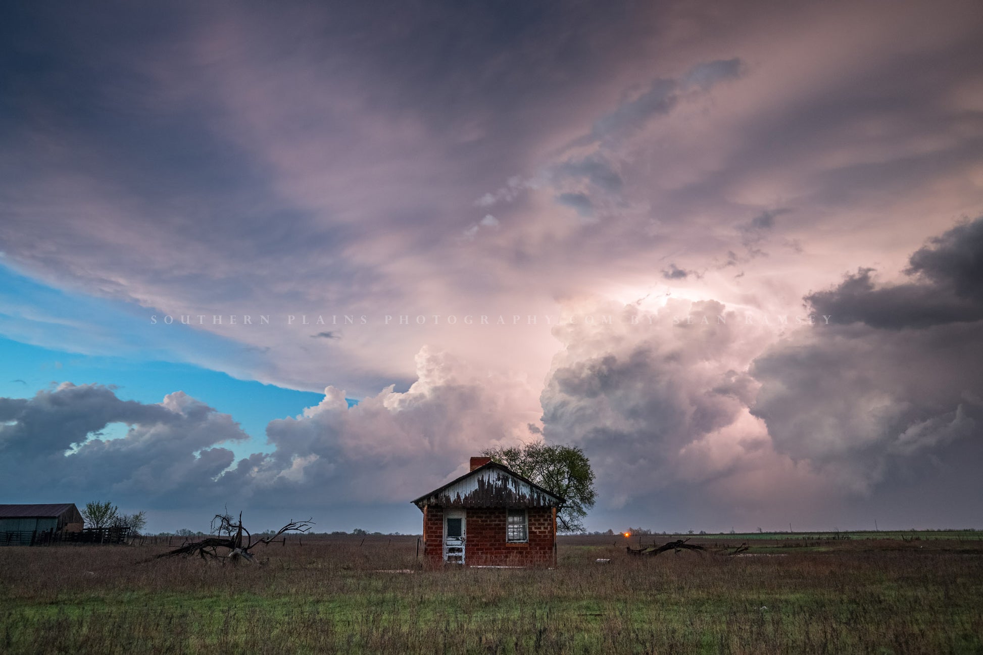 Storm photography print of a stormy sky illuminated by lightning behind a tiny house on the plains of Oklahoma by Sean Ramsey of Southern Plains Photography.