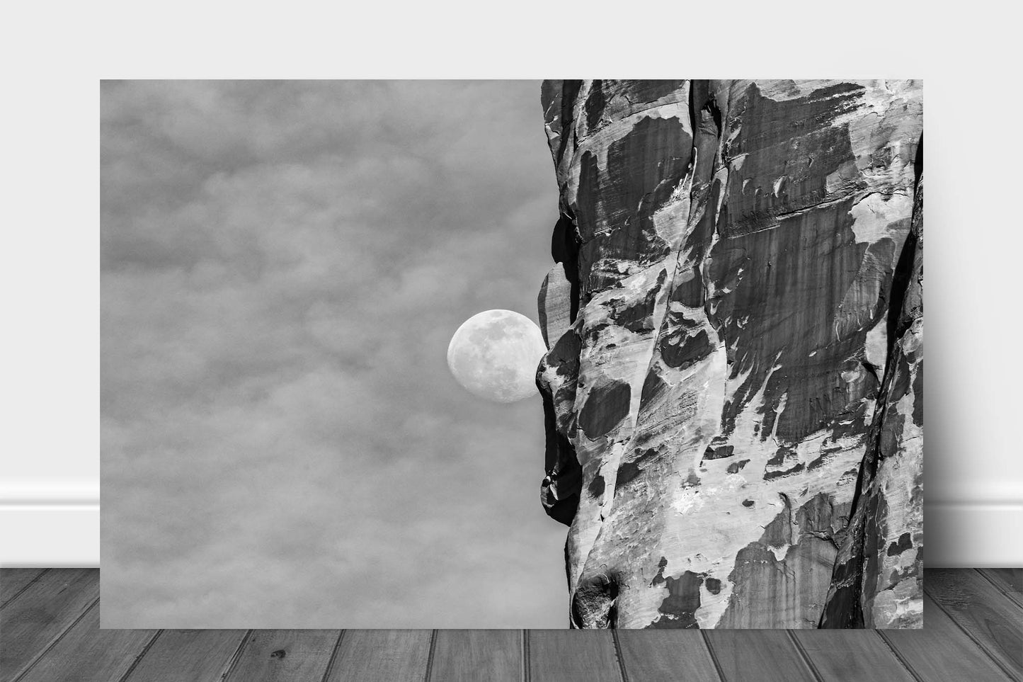 Black and white Southwest aluminum metal print wall art of a Waning Gibbous Moon beside a sandstone cliff in Arches National Park, Utah by Sean Ramsey of Southern Plains Photography.