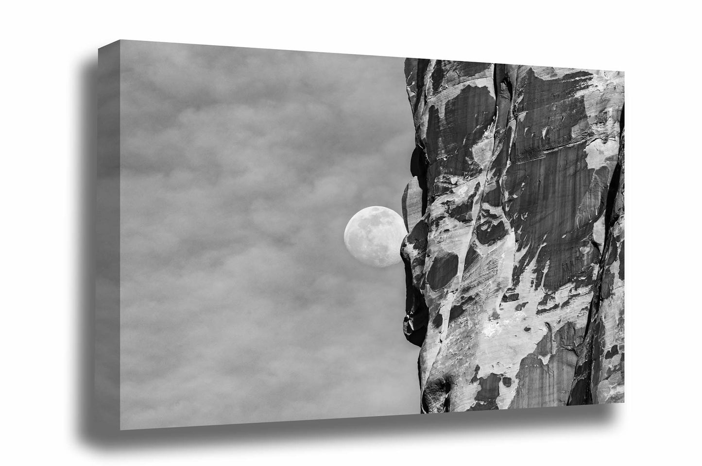 Black and white Southwest gallery wrapped canvas wall art of a Waning Gibbous Moon beside a sandstone cliff in Arches National Park, Utah by Sean Ramsey of Southern Plains Photography.