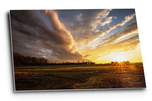 Southeastern metal print wall art of a warm sunset over a farm after a stormy day in the Mississippi Delta in Mississippi by Sean Ramsey of Southern Plains Photography.