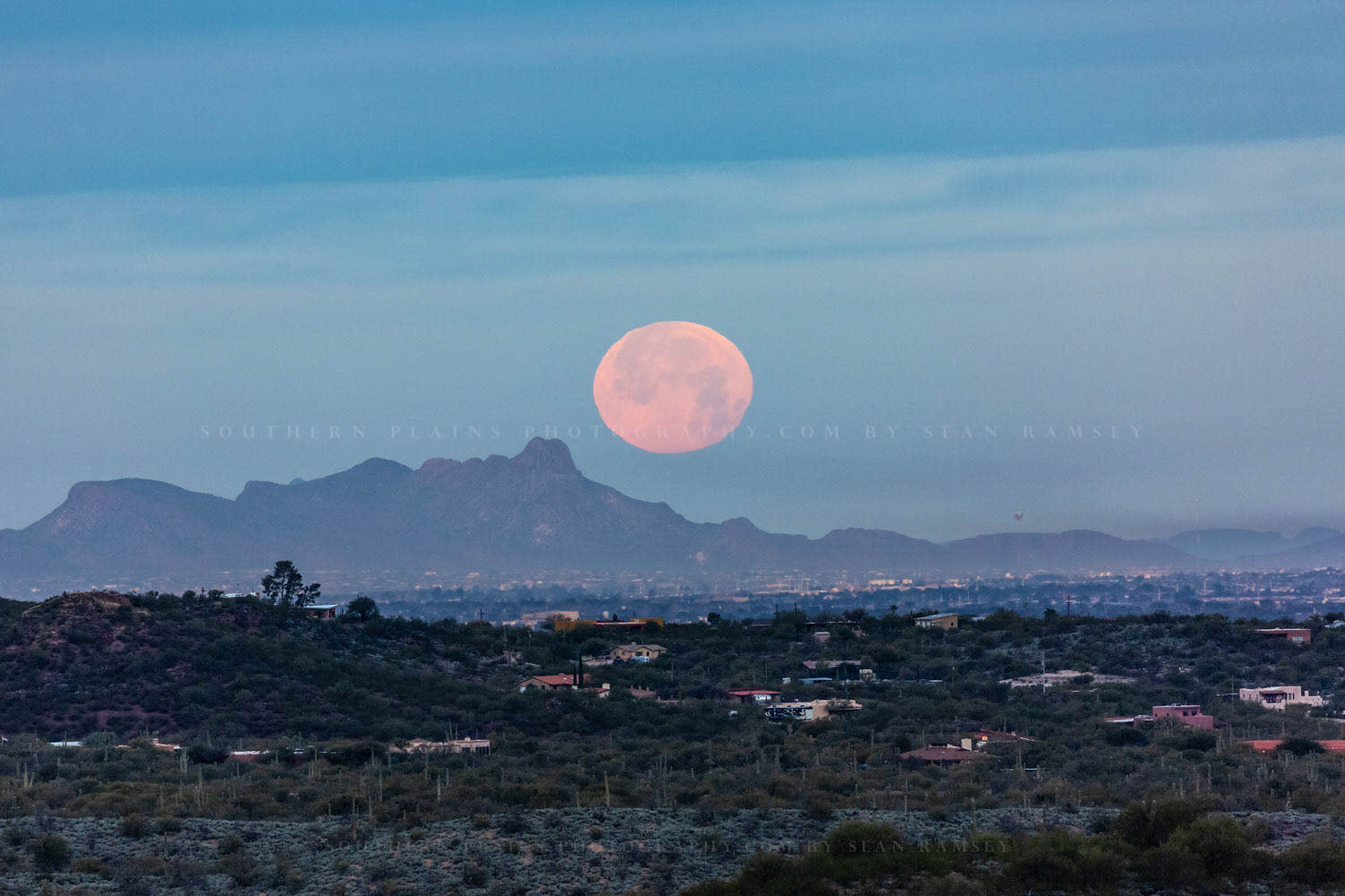 Southwestern photography print of a full moon sets over the mountains at sunrise in Tucson, Arizona by Sean Ramsey of Southern Plains Photography.