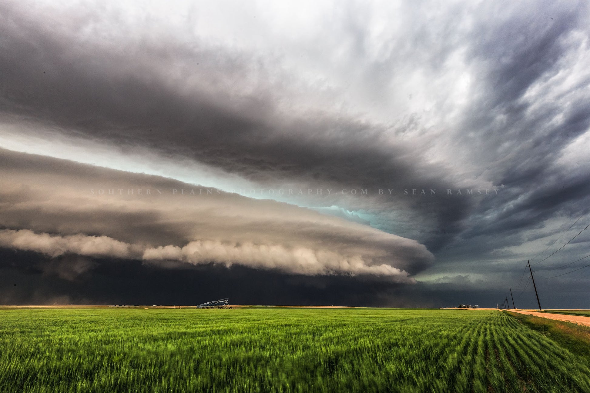 Storm photography print of a supercell thunderstorm shelf cloud over a green field on a stormy spring day in Kansas by Sean Ramsey of Southern Plains Photography.