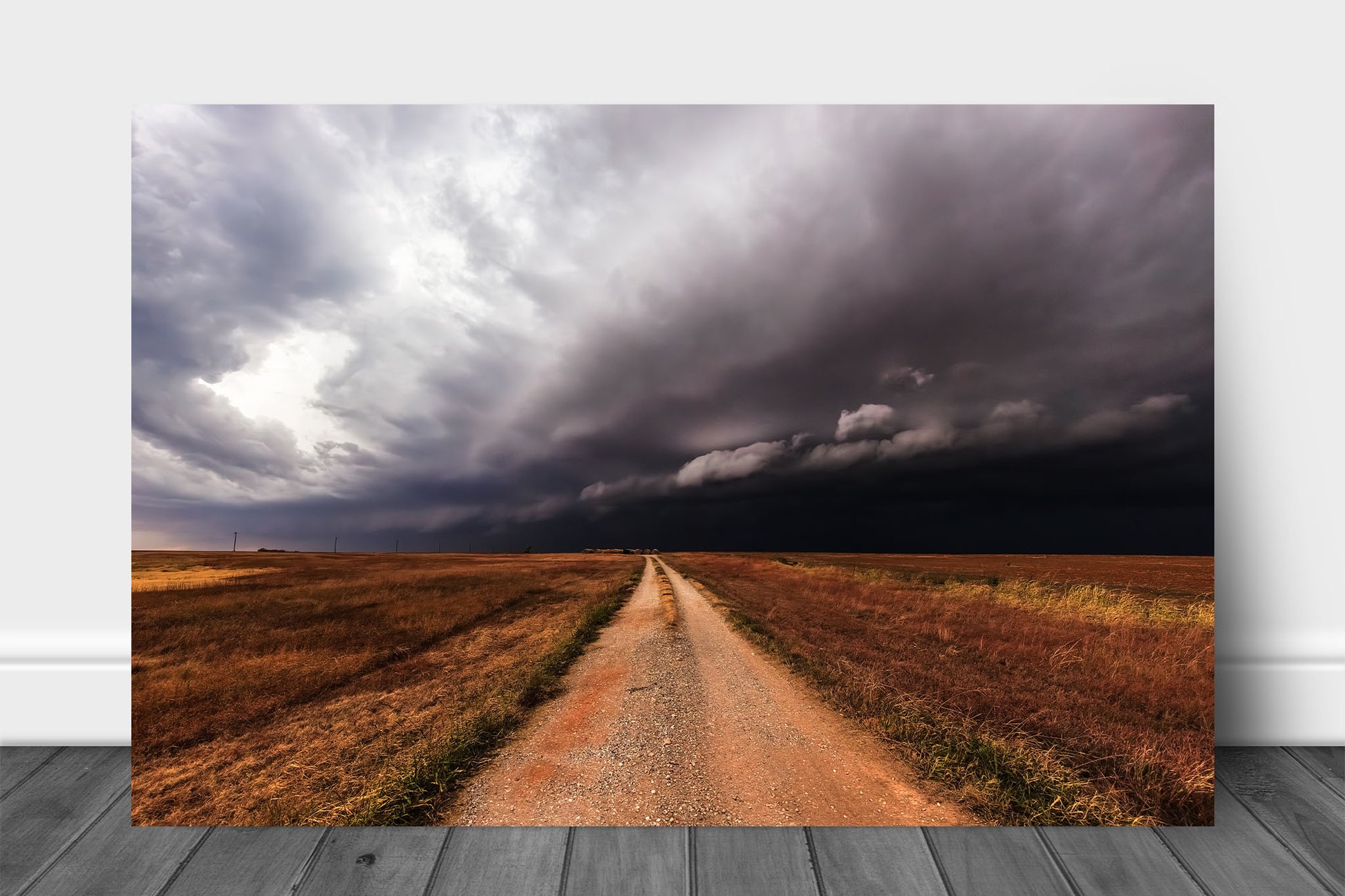 Storm aluminum metal print wall art of a dirt road leading to a thunderstorm as it advances over open plains in Oklahoma by Sean Ramsey of Southern Plains Photography.
