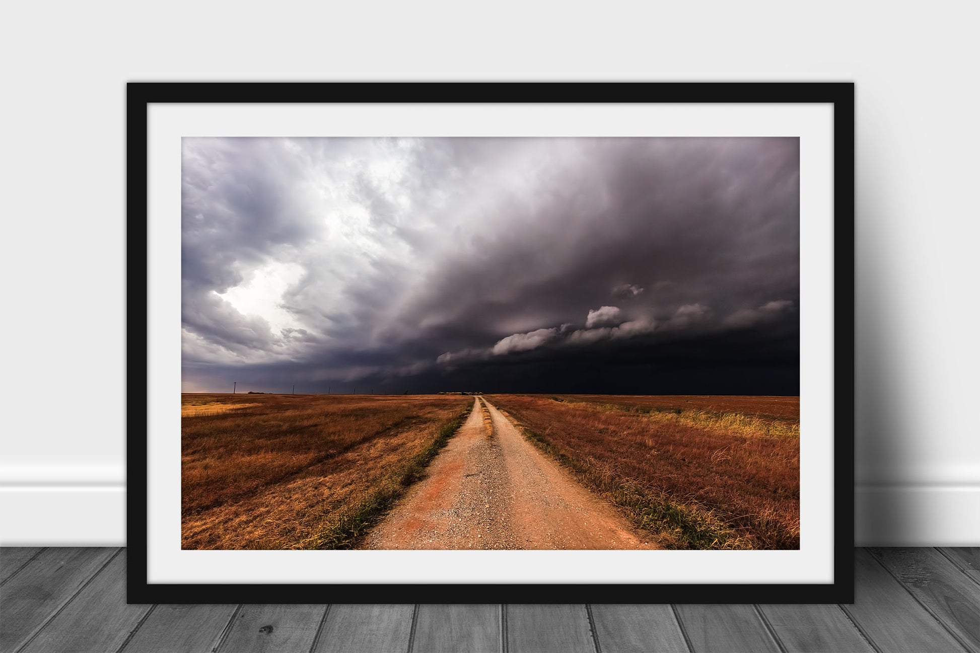 Storm framed print of a dirt road leading to a thunderstorm as it advances over open plains in Oklahoma by Sean Ramsey of Southern Plains Photography.