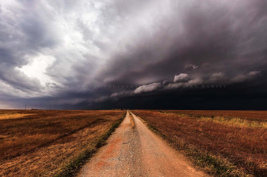 Storm photography print of a dirt road leading to a thunderstorm as it advances over open plains in Oklahoma by Sean Ramsey of Southern Plains Photography.