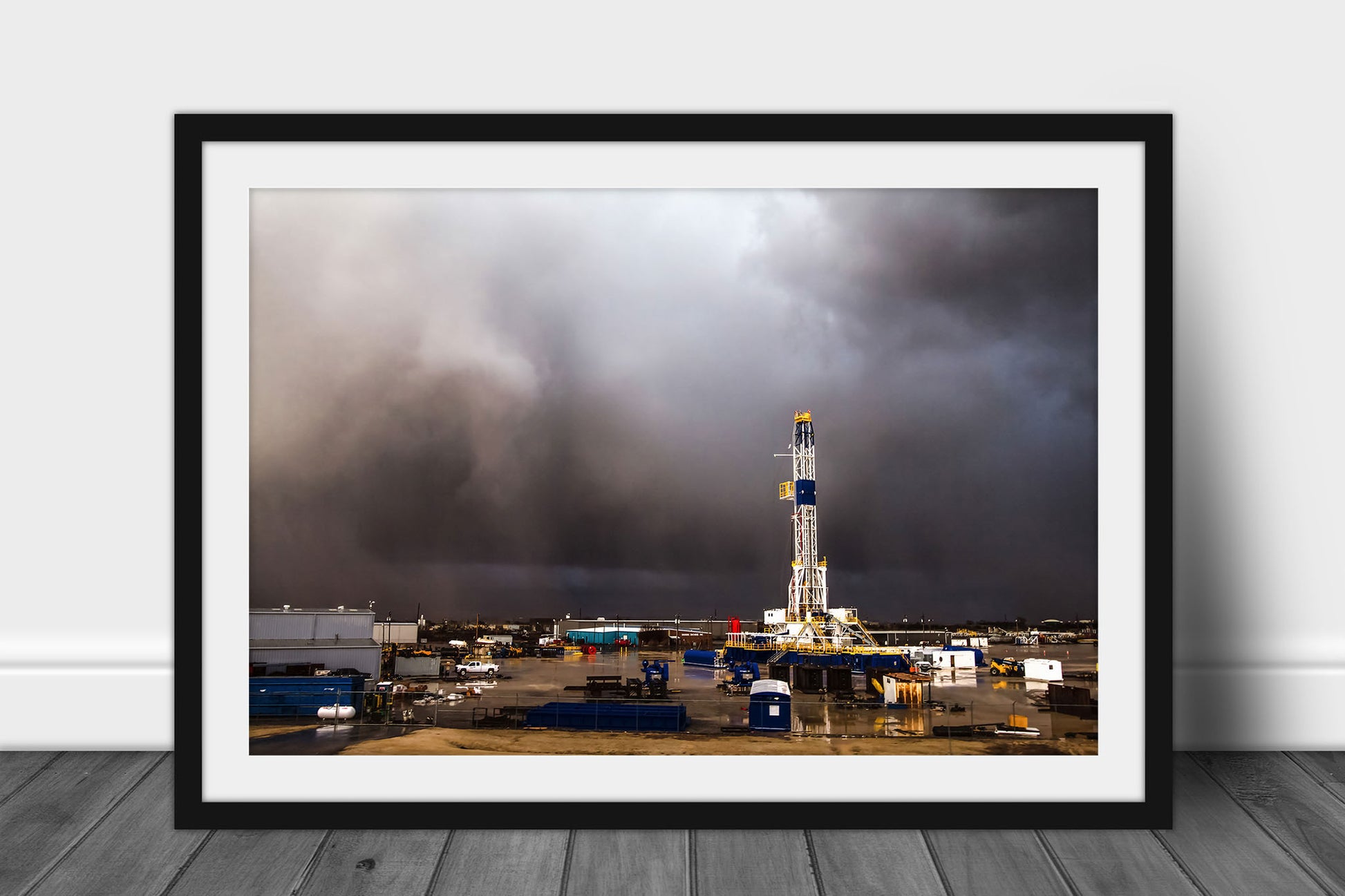 Framed and matted oilfield print of a drilling rig derrick standing tall as an intense storm passes by on a stormy spring day in Oklahoma by Sean Ramsey of Southern Plains Photography.