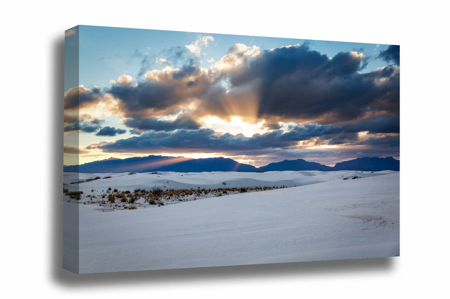 Desert southwest canvas wall art of sunbeams bursting from behind clouds over the San Andres Mountains at sunset at White Sands National Park, New Mexico by Sean Ramsey of Southern Plains Photography.