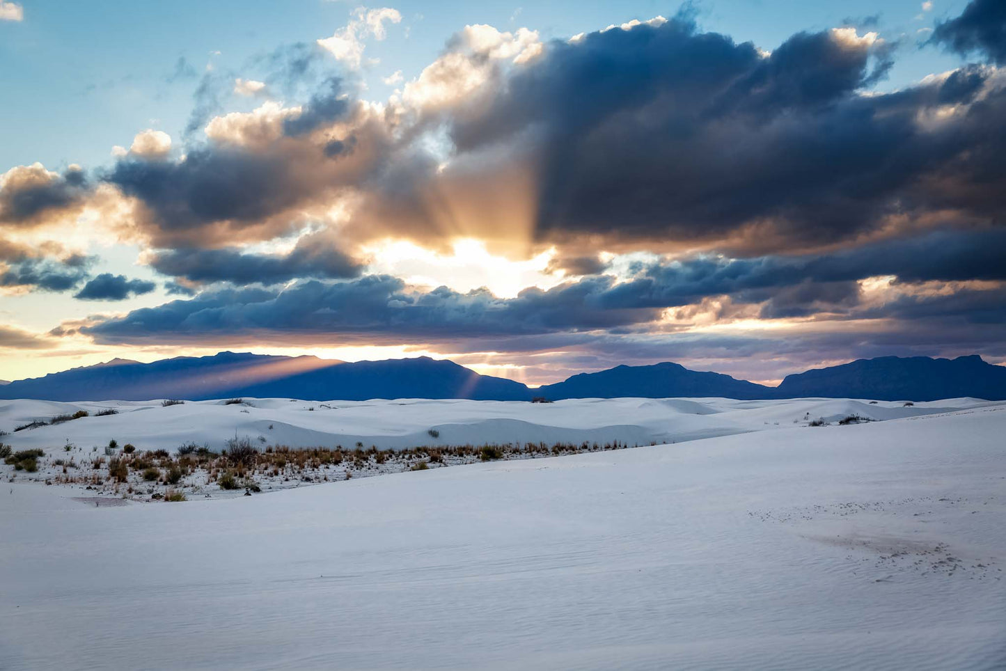 Desert southwest photography print of sunbeams bursting from behind clouds over the San Andres Mountains at White Sands National Park near Alamogordo, New Mexico by Sean Ramsey of Southern Plains Photography.
