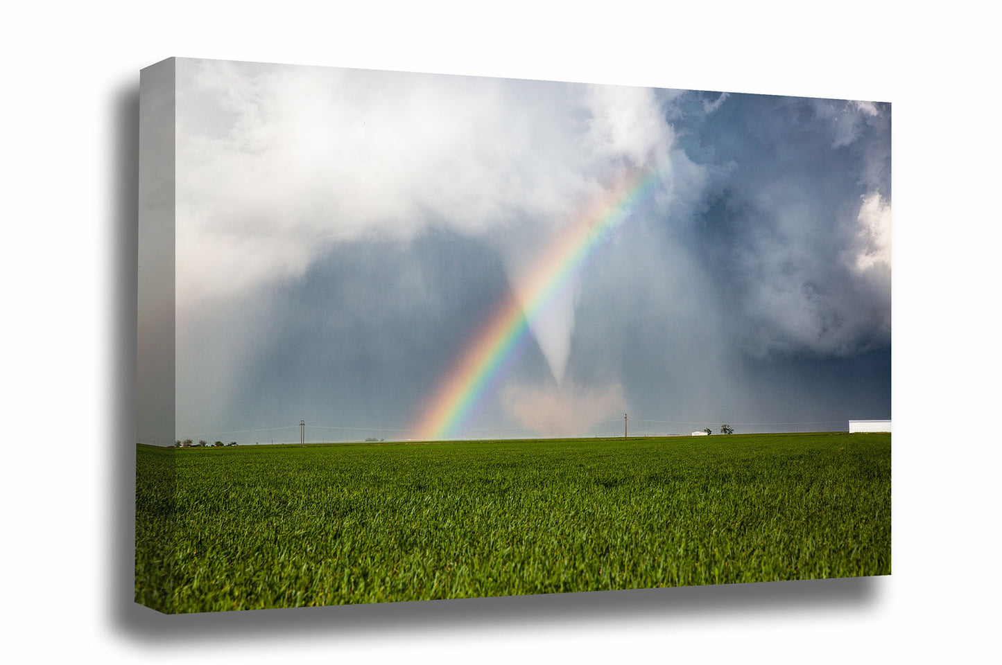 Storm canvas wall art of a tornado passing through a rainbow over a green field on a stormy spring day in Texas by Sean Ramsey of Southern Plains Photography.