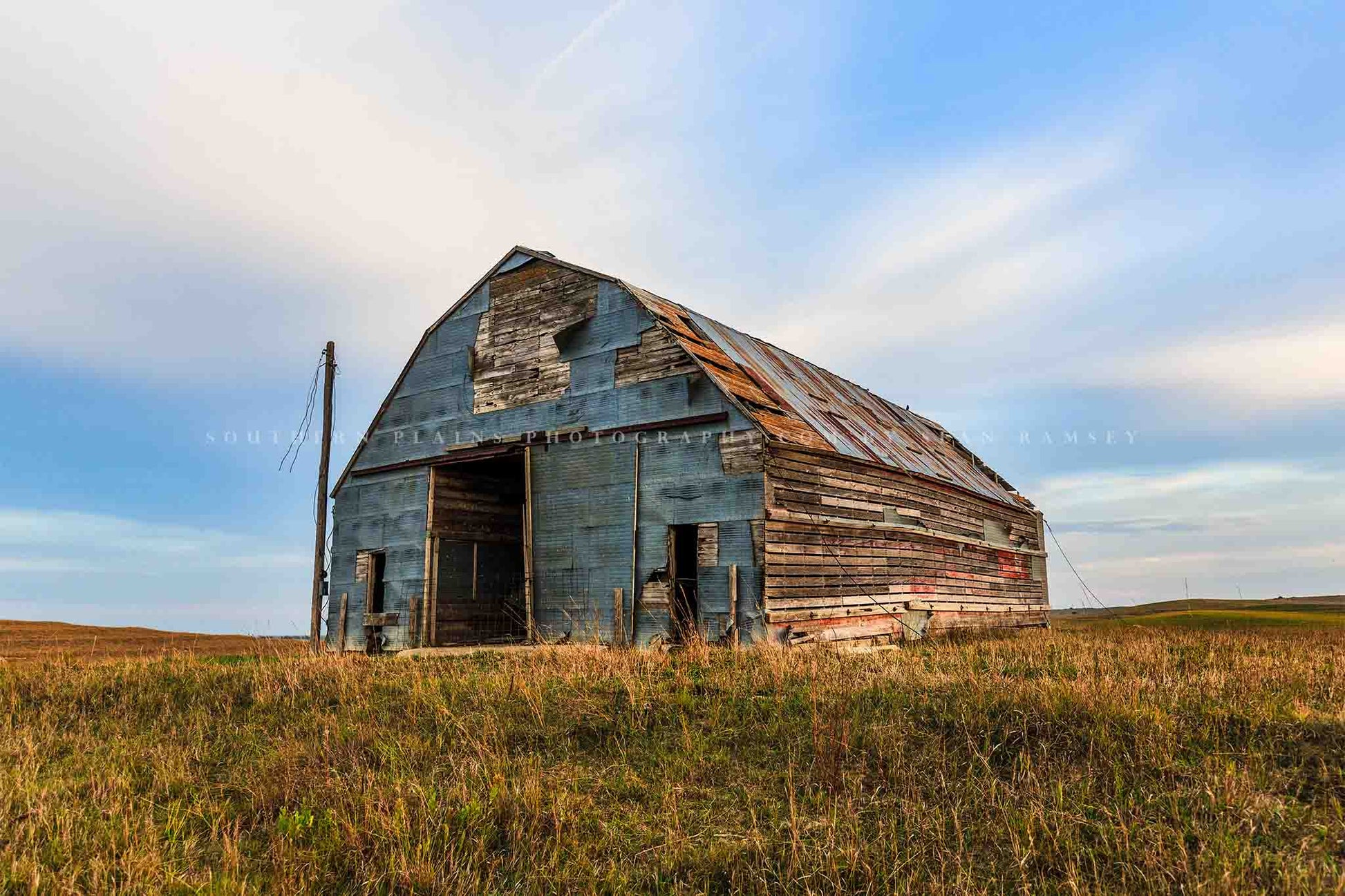 Rural Midwest photography print of an old barn covered by a patchwork of tin in the Nebraska Sandhills by Sean Ramsey of Southern Plains Photography.
