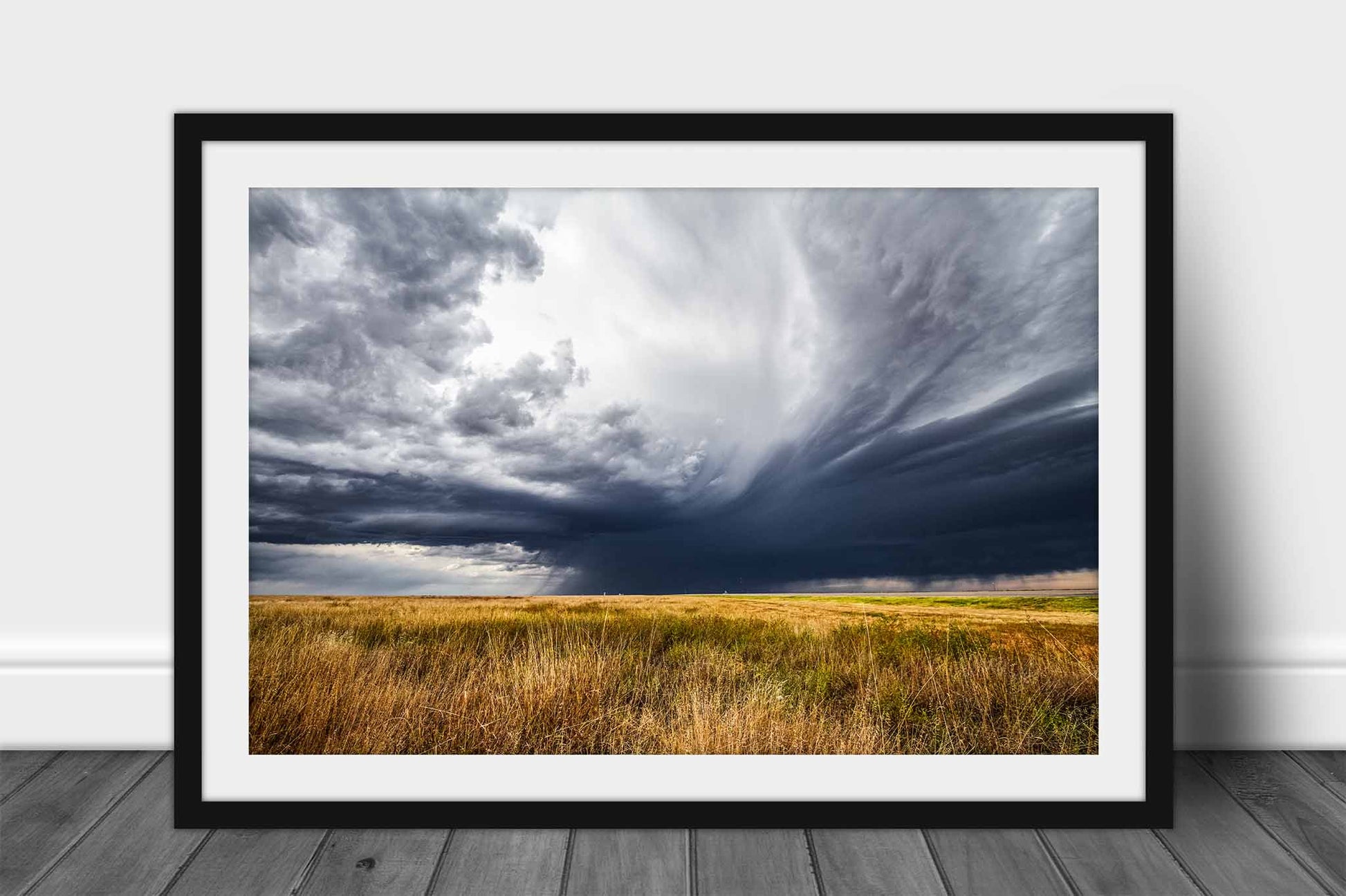 Framed thunderstorm print wall art of a dramatic stormy sky over golden prairie grass on a spring day in the Oklahoma Panhandle by Sean Ramsey of Southern Plains Photography.