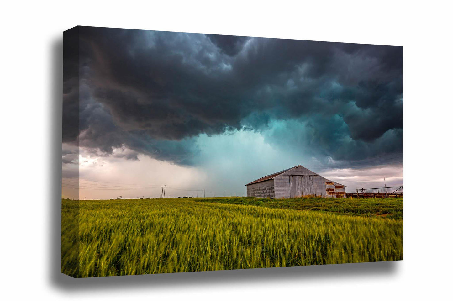 Storm canvas wall art of a thunderstorm passing behind a tin covered barn in a wheat field on a stormy spring day in Oklahoma by Sean Ramsey of Southern Plains Photography.