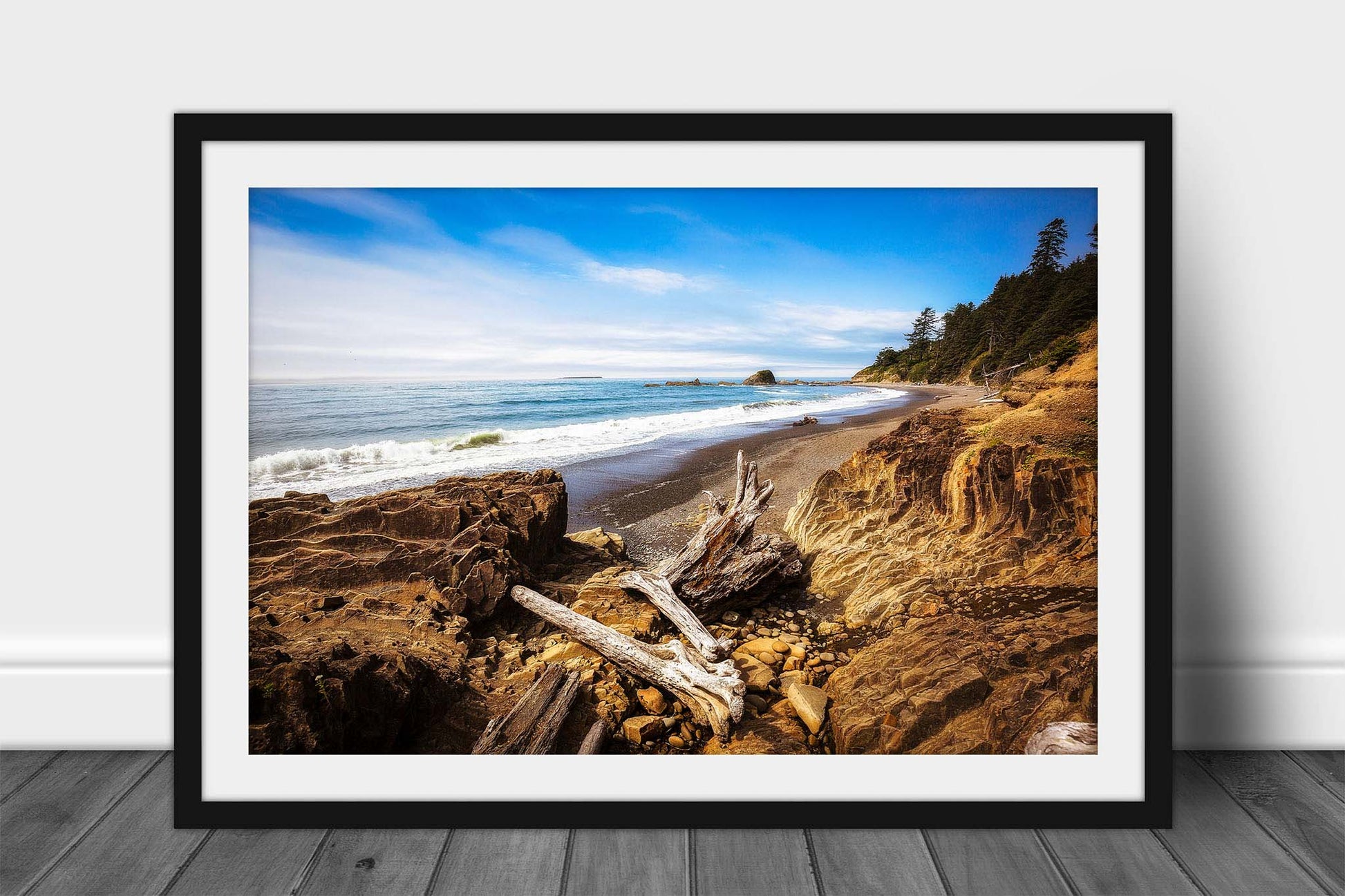 Framed and matted Pacific Northwest coastal print of driftwood logs resting on the shore along a beach in Washington state by Sean Ramsey of Southern Plains Photography.