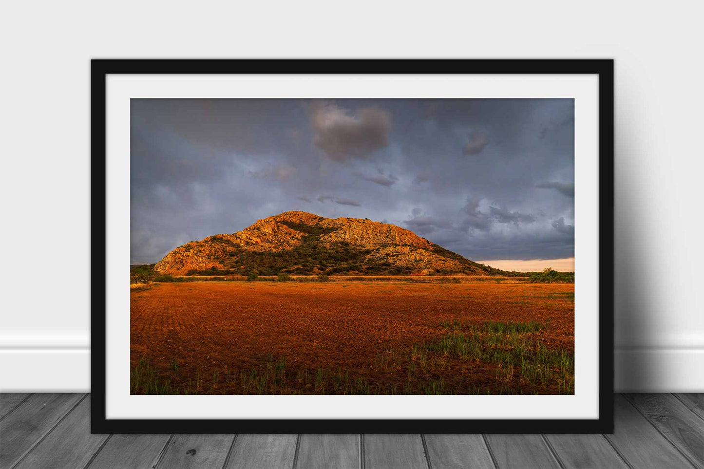 Framed landscape print wall art of the Quartz Mountains rising abruptly over a field as a thunderstorm passes overhead in southwest Oklahoma by Sean Ramsey of Southern Plains Photography.