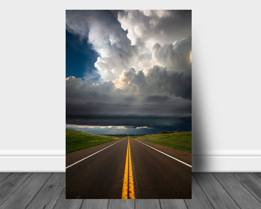 Vertical storm metal print of a supercell thunderstorm over a highway with double yellow lines on a stormy spring day in Kansas by Sean Ramsey of Southern Plains Photography.