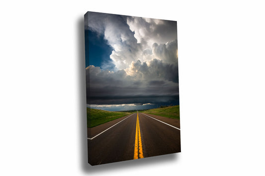 Vertical storm canvas wall art of a supercell thunderstorm over a highway with double yellow lines on a stormy spring day in Kansas by Sean Ramsey of Southern Plains Photography.