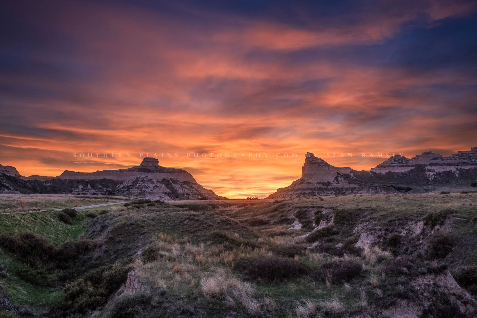 Prairie photography print of a vivid sunset taking place over Scotts Bluff National Monument near Scottsbluff, Nebraska by Sean Ramsey of Southern Plains Photography.