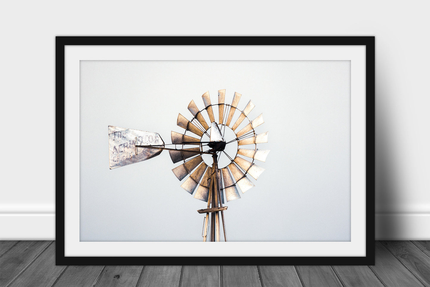 Framed and matted rustic farmhouse print of a rusted windmill head against a gray sky on a stormy day in Oklahoma by Sean Ramsey of Southern Plains Photography.