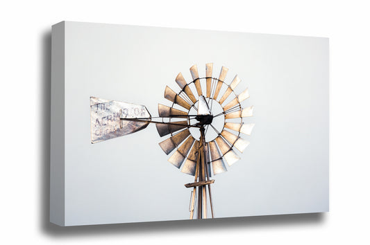 Rustic farmhouse canvas wall art of a rusty windmill head against a gray sky on a farm in Oklahoma by Sean Ramsey of Southern Plains Photography.