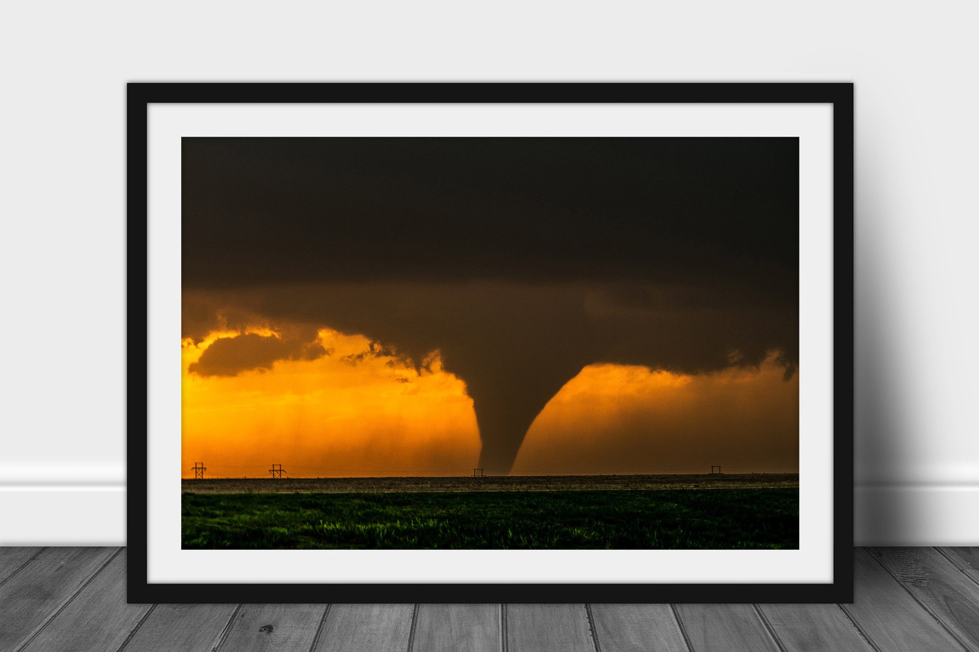 Framed and matted weather print of a large tornado appearing as a silhouette against the evening sky at sunset on a stormy spring day in Kansas by Sean Ramsey of Southern Plains Photography.