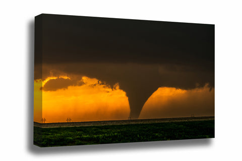 Storm canvas wall art of a large tornado appearing as a silhouette against the evening sky at sunset on a stormy spring evening in Kansas by Sean Ramsey of Southern Plains Photography.