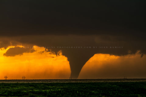 Storm photography print of a large tornado appearing as a silhouette against an orange sky at sunset on a stormy spring evening in Kansas by Sean Ramsey of Southern Plains Photography.