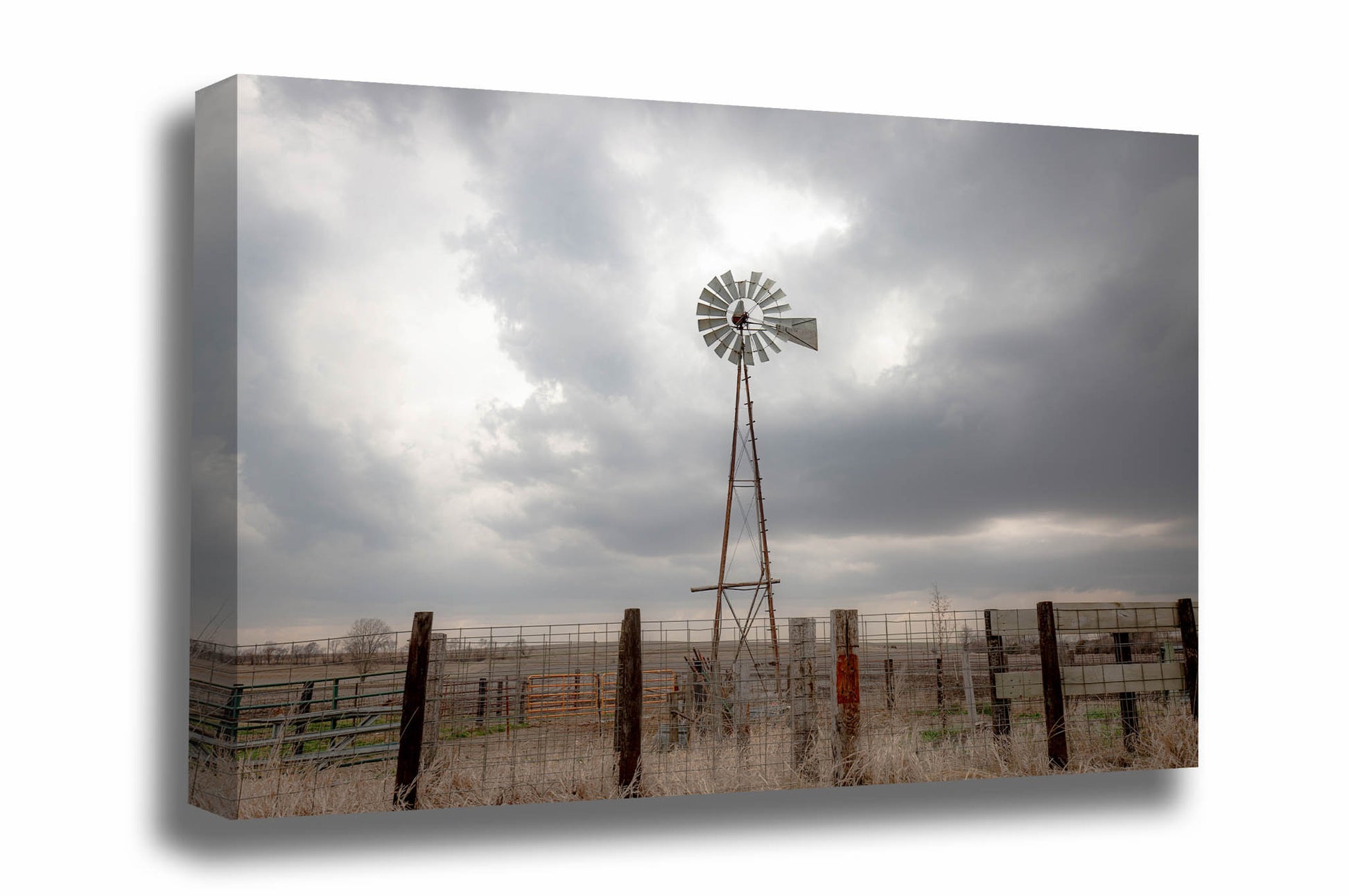 Midwestern canvas wall art of an old windmill standing tall against a silver sky on a stormy spring day in Iowa by Sean Ramsey of Southern Plains Photography.