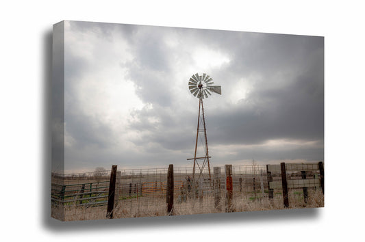 Midwestern canvas wall art of an old windmill standing tall against a silver sky on a stormy spring day in Iowa by Sean Ramsey of Southern Plains Photography.