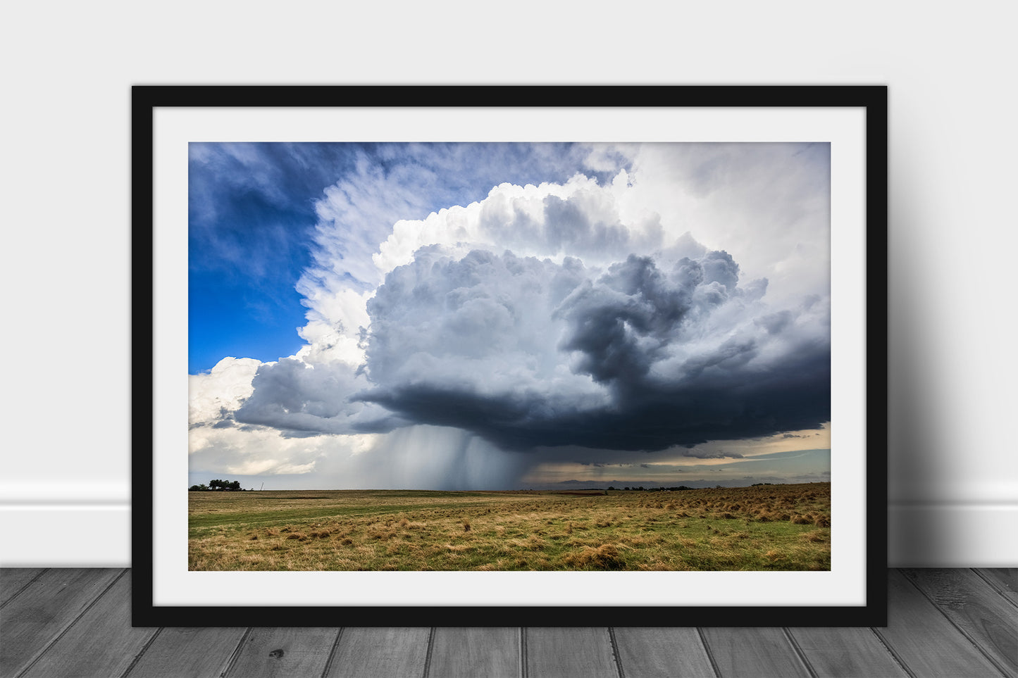 Framed thunderstorm print of a large storm cloud dropping rain over open plains on a stormy spring day in Oklahoma by Sean Ramsey of Southern Plains Photography.