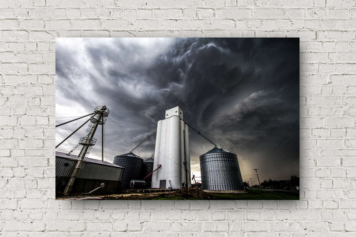 Thunderstorm metal print on aluminum of storm clouds swirling over a grain elevator in a small town in Kansas by Sean Ramsey of Southern Plains Photography.