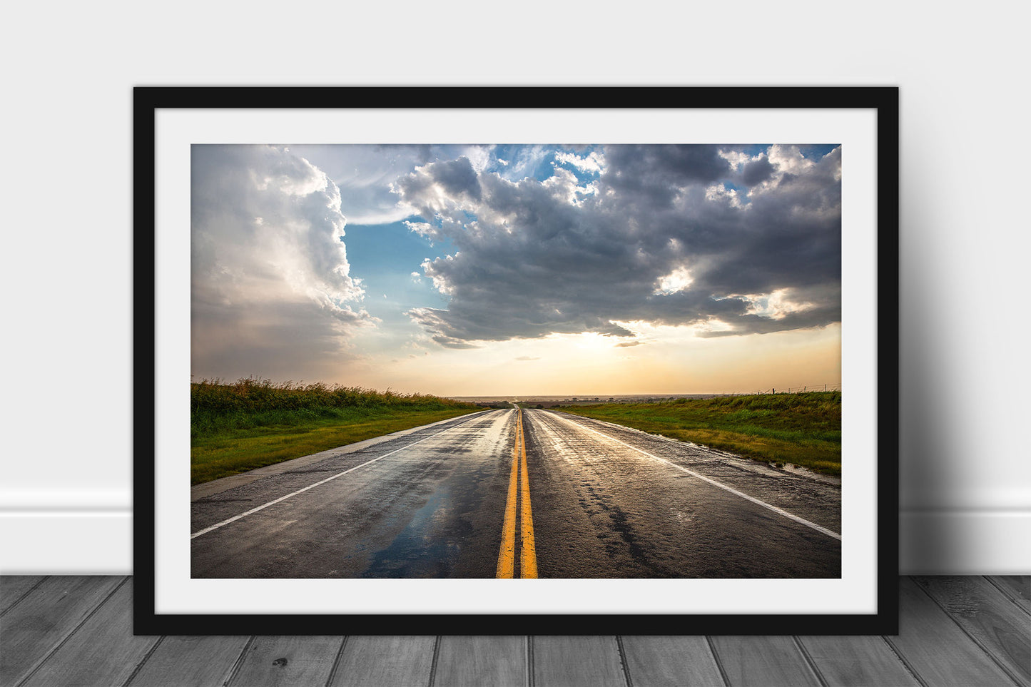 Framed and matted road print of a rain soaked highway going on forever as golden sunlight begins to fill the sky after a stormy day in Oklahoma by Sean Ramsey of Southern Plains Photography.
