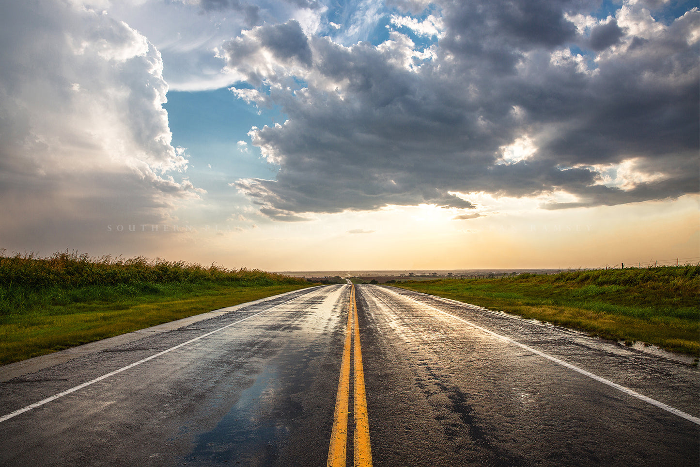 Road photography print of a rain soaked highway going on forever as golden sunlight begins to fill the sky after a stormy day in Oklahoma by Sean Ramsey of Southern Plains Photography.