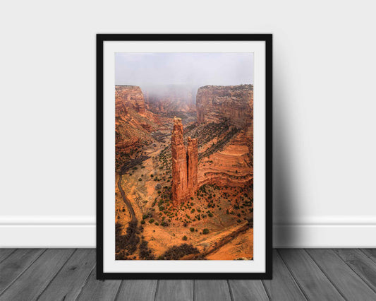 Vertical framed and matted desert southwest print of Spider Rock as a snow squall moves through Canyon de Chelly near Chinle, Arizona by Sean Ramsey of Southern Plains Photography.