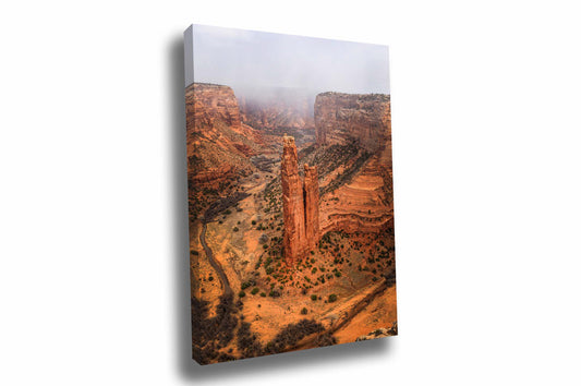 Vertical southwestern landscape canvas wall art of Spider Rock rising from the floor of Canyon de Chelly as a snow squall passes through on a late winter day near Chinle, Arizona by Sean Ramsey of Southern Plains Photography.