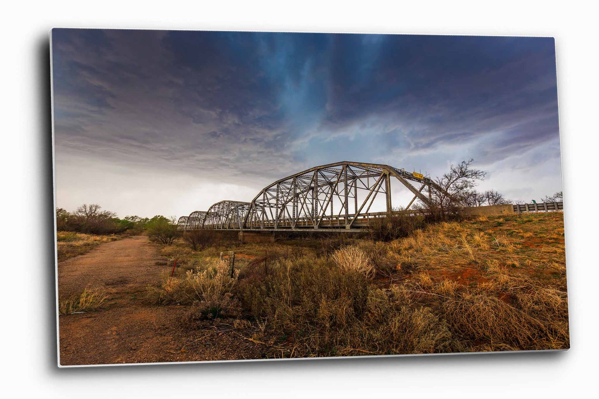 Storm aluminum metal print wall art of an aqua colored thunderstorm over and old bridge in the Texas Panhandle by Sean Ramsey of Southern Plains Photography.