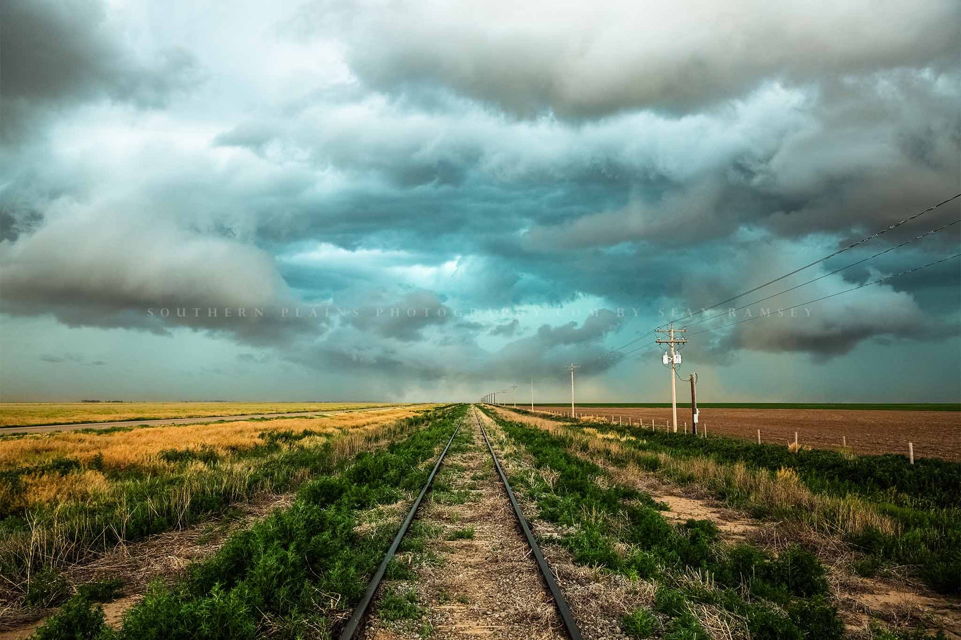 Railroad photography print of train tracks leading to a stormy sky on the plains of Colorado by Sean Ramsey of Southern Plains Photography.