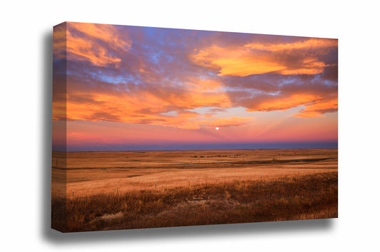 Great Plains canvas wall art of clouds illuminated by morning sunlight surrounding a full moon over golden prairie at sunrise in Colorado by Sean Ramsey of Southern Plains Photography.
