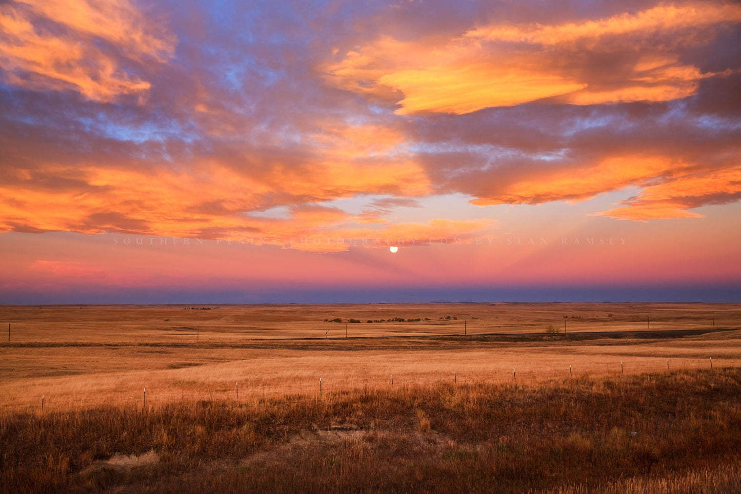 Great Plains photography print of clouds illuminated by morning sunlight over a full moon at sunrise on the Colorado prairie by Sean Ramsey of Southern Plains Photography.