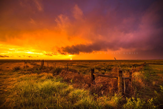 Great plains photography print of a vivid sunset taking place in a stormy sky over a barbed wire fence on a spring evening in Oklahoma by Sean Ramsey of Southern Plains Photography.