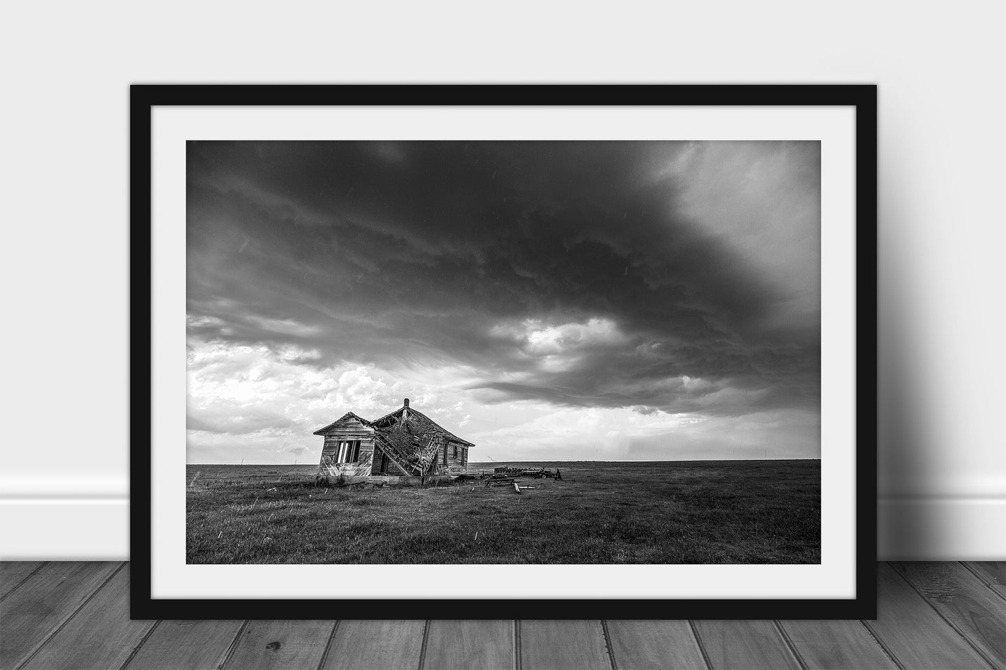 Framed and matted black and white abandoned house print of an old homestead under an advancing thunderstorm on a stormy day on the open plains of Oklahoma by Sean Ramsey of Southern Plains Photography.