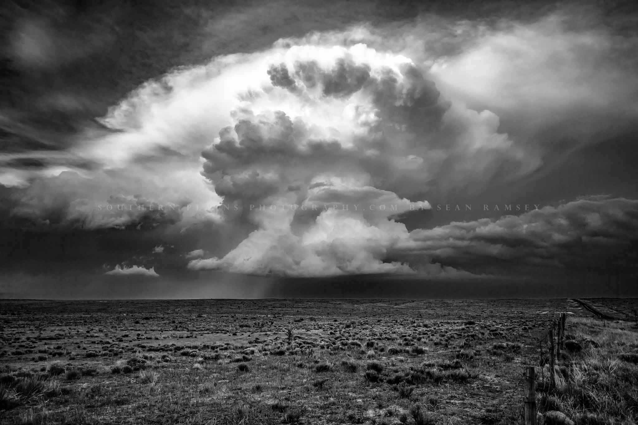 Black and white storm photography print of a supercell thunderstorm climbing high into the sky over the high plains of the Oklahoma panhandle in black and white by Sean Ramsey of Southern Plains Photography.