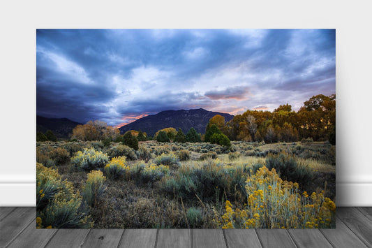 Rocky Mountain landscape aluminum metal print wall art of Taos Mountain under a stormy sky at sunrise on an autumn morning near Taos, New Mexico by Sean Ramsey of Southern Plains Photography.