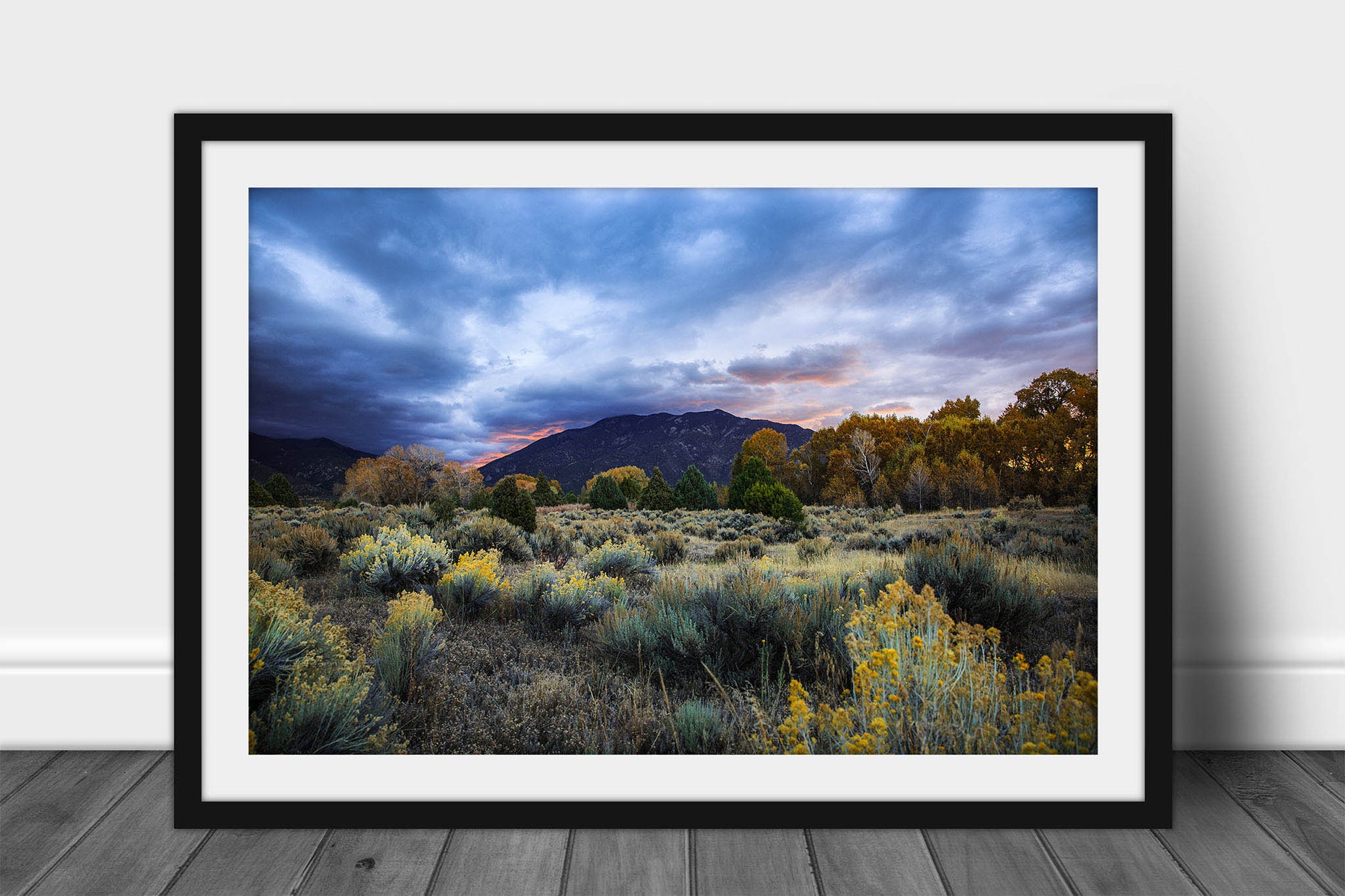 Framed and matted Rocky Mountain landscape print of Taos Mountain under a stormy sky at sunrise on an autumn morning near Taos, New Mexico by Sean Ramsey of Southern Plains Photography.