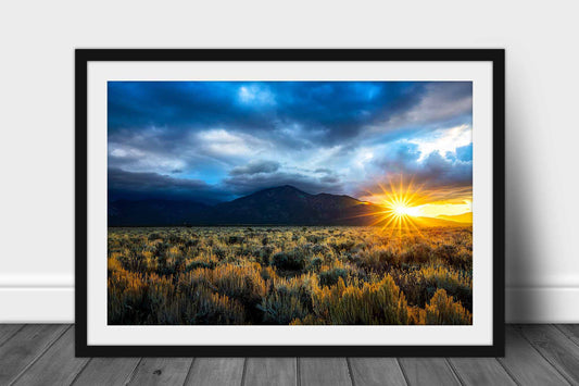 Framed and matted southwestern print of the sun twinkling from behind Taos Mountain on an autumn morning near Taos, New Mexico by Sean Ramsey of Southern Plains Photography.