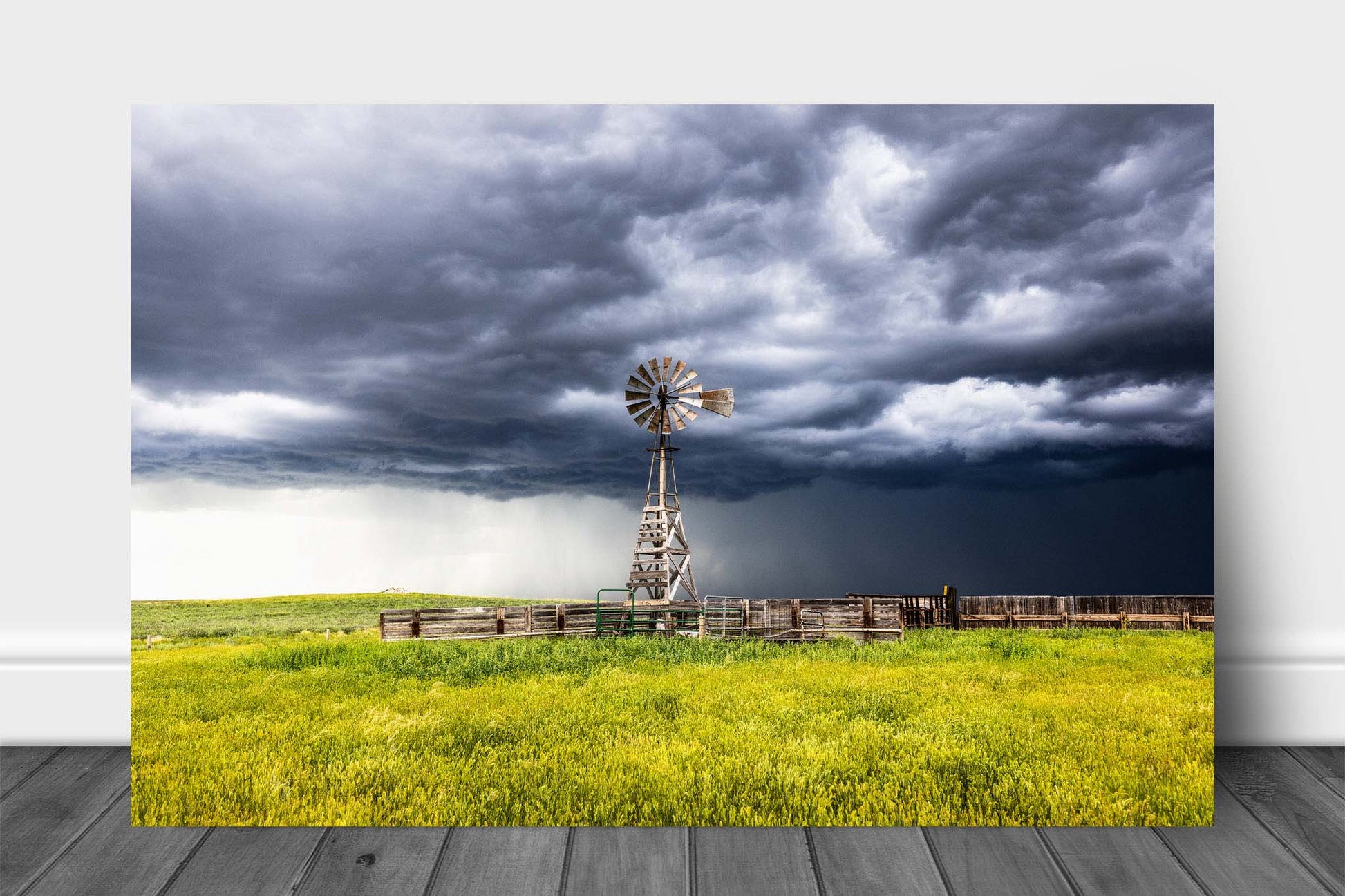 Western aluminum metal print wall art of a storm advancing over an old windmill and cattle pens on a stormy spring day on the plains of Wyoming by Sean Ramsey of Southern Plains Photography.