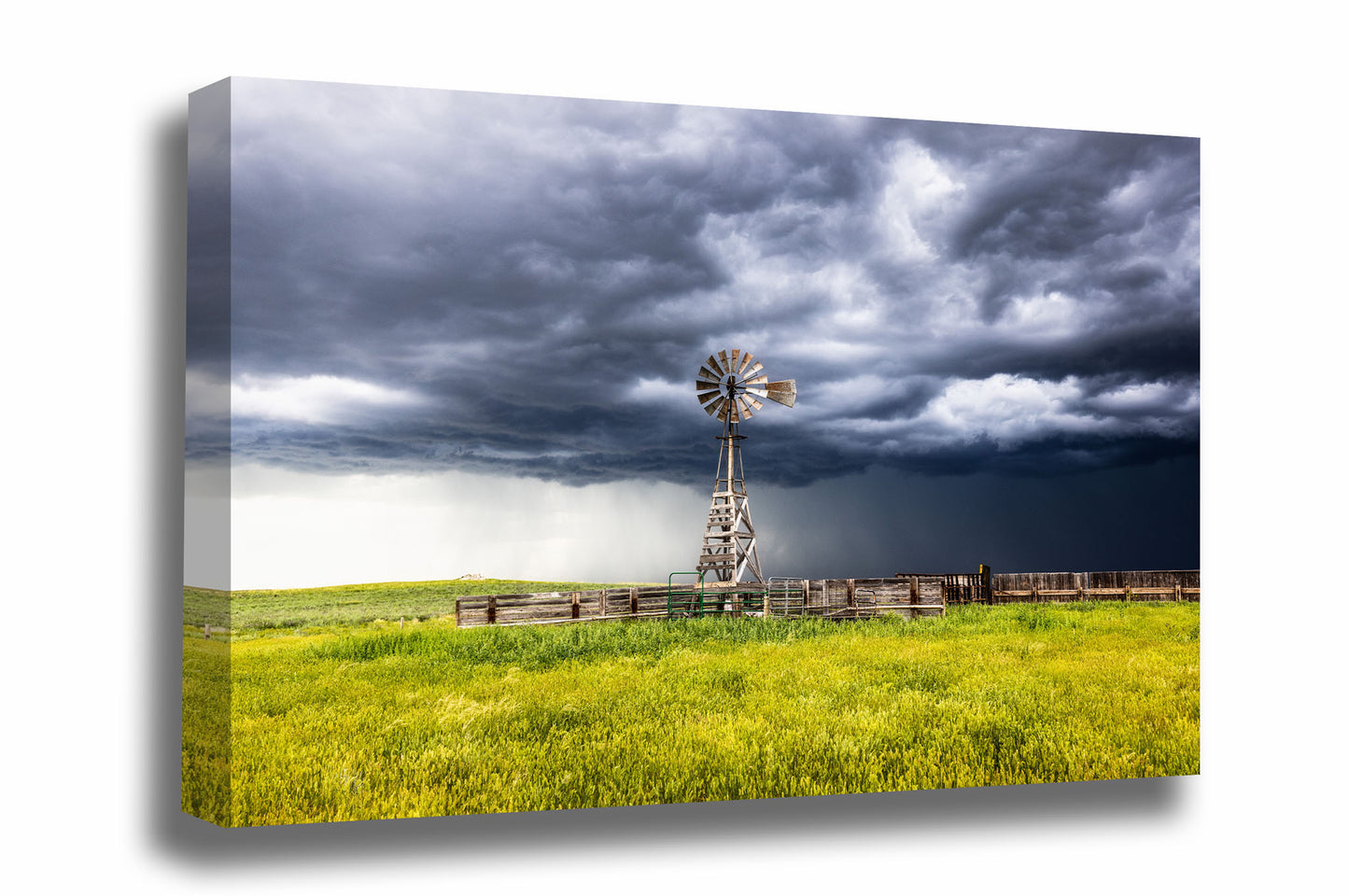 Western canvas wall art of a storm advancing over an old windmill and cattle pens on a stormy spring day on the plains of Wyoming by Sean Ramsey of Southern Plains Photography.